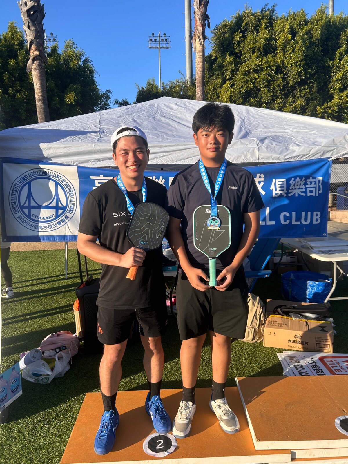 Eric Ng with a young athlete after competition