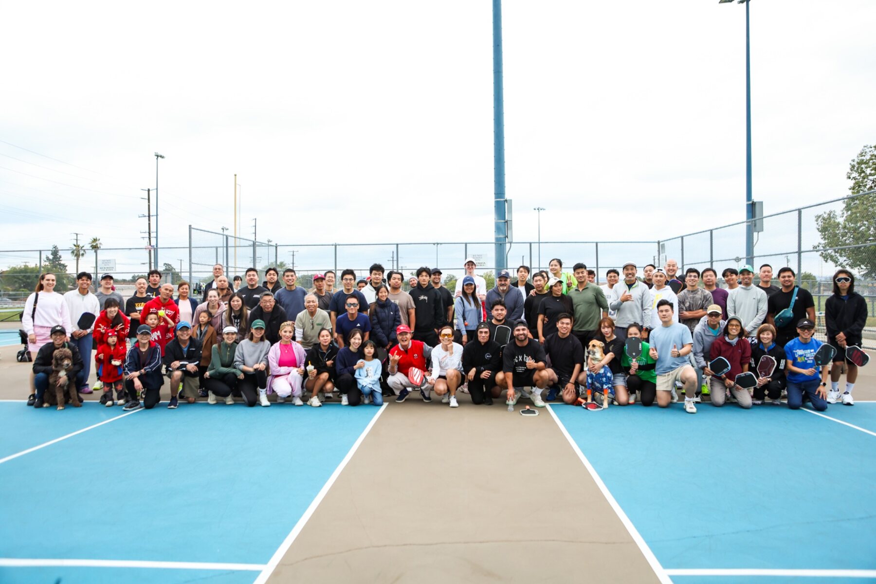 A large NGSG community gathering on the pickleball courts