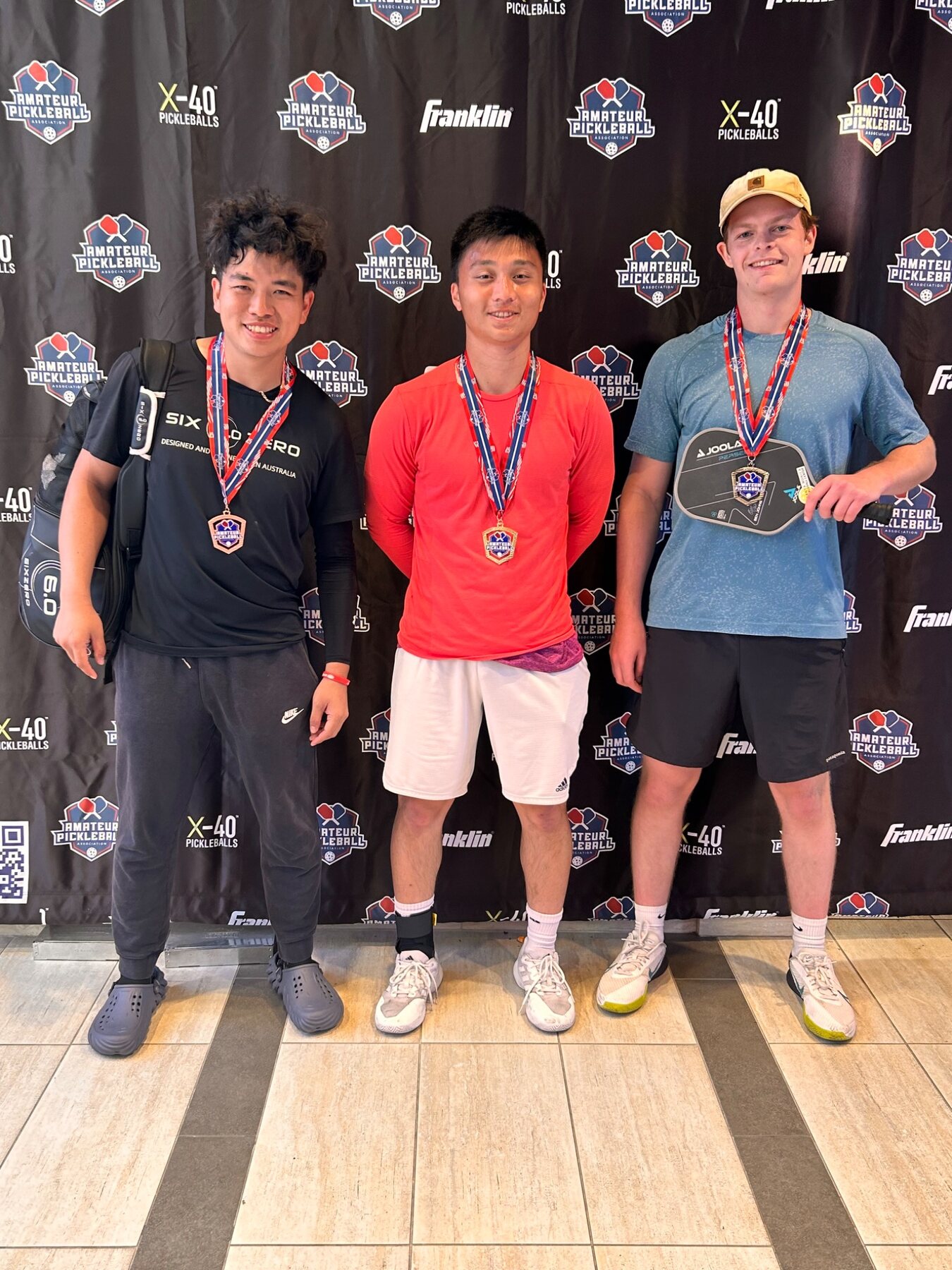 Three medalists at an Amateur Pickleball Association event