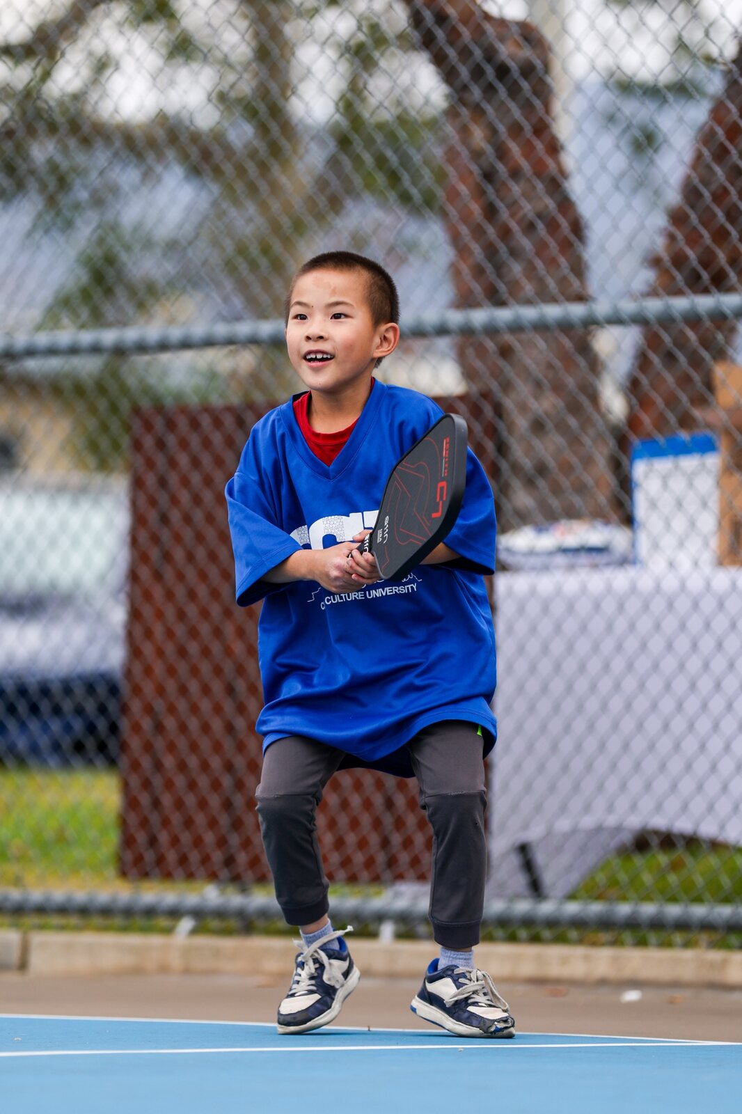 Young athlete enjoying pickleball at a community event