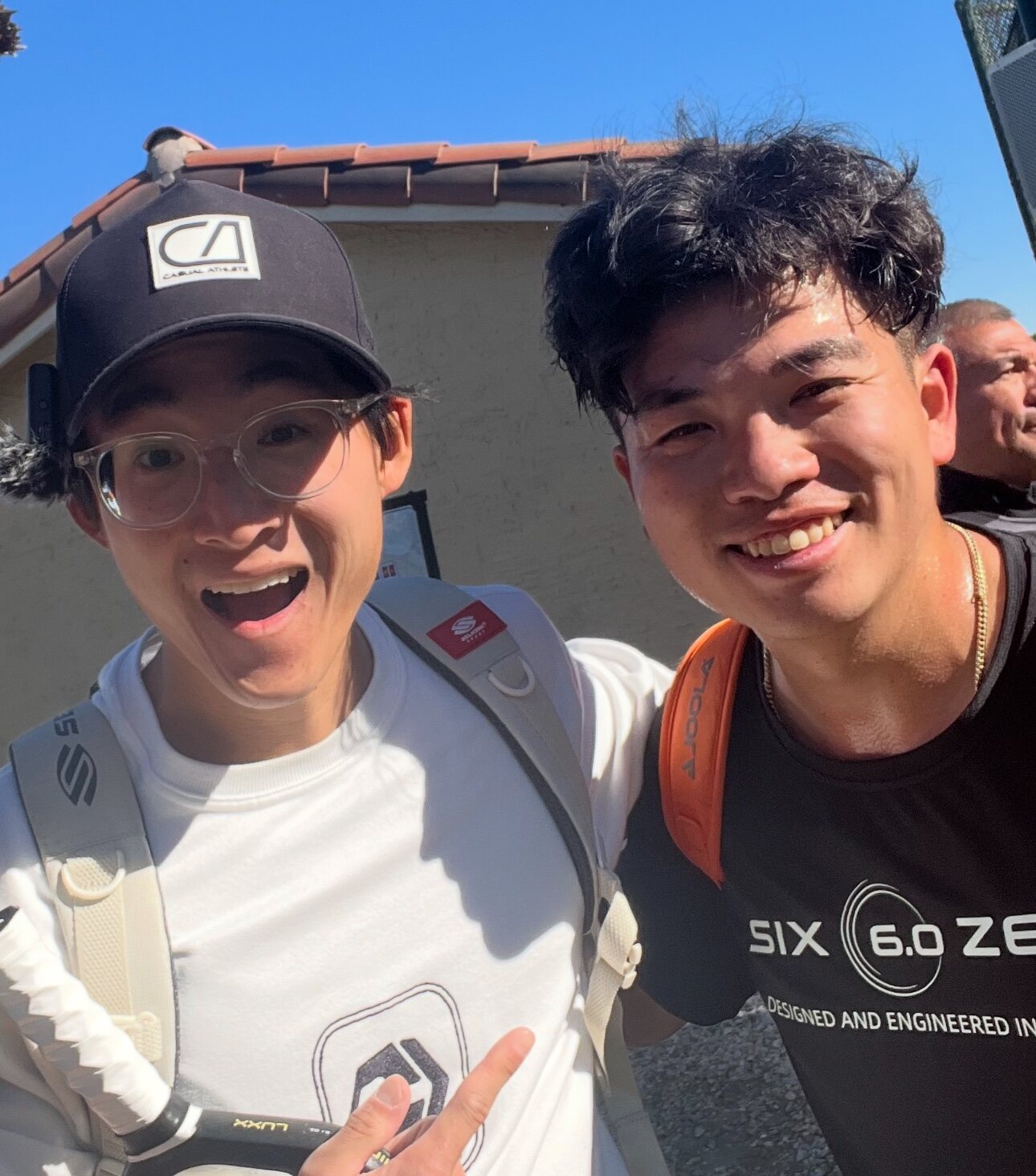 Two pickleball players smiling together at an event