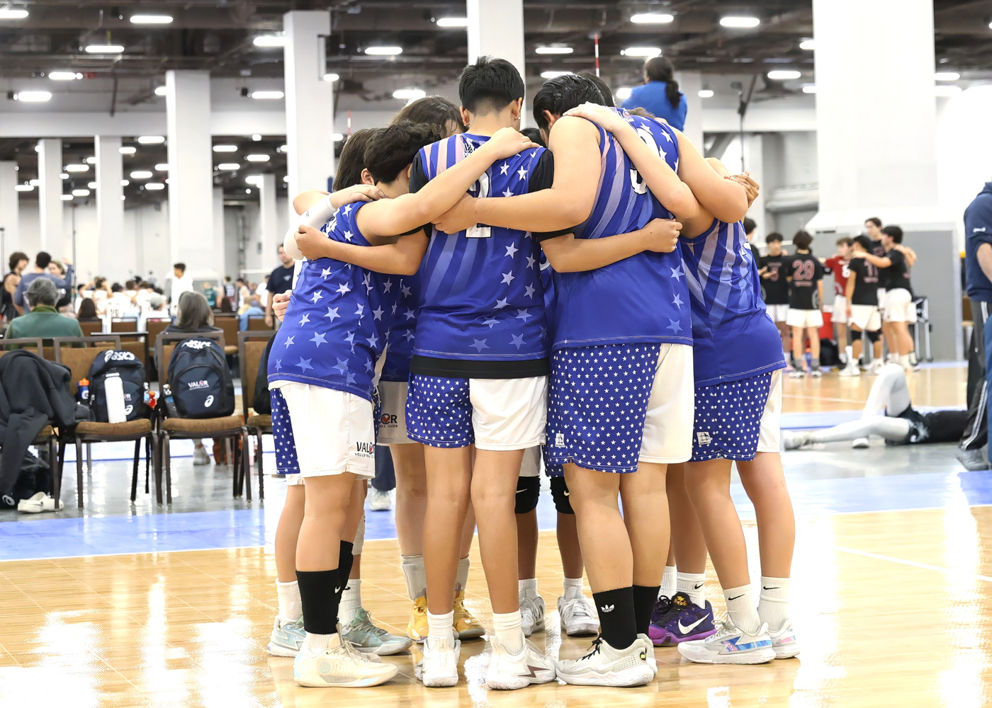 Young volleyball athletes gathered in a team huddle